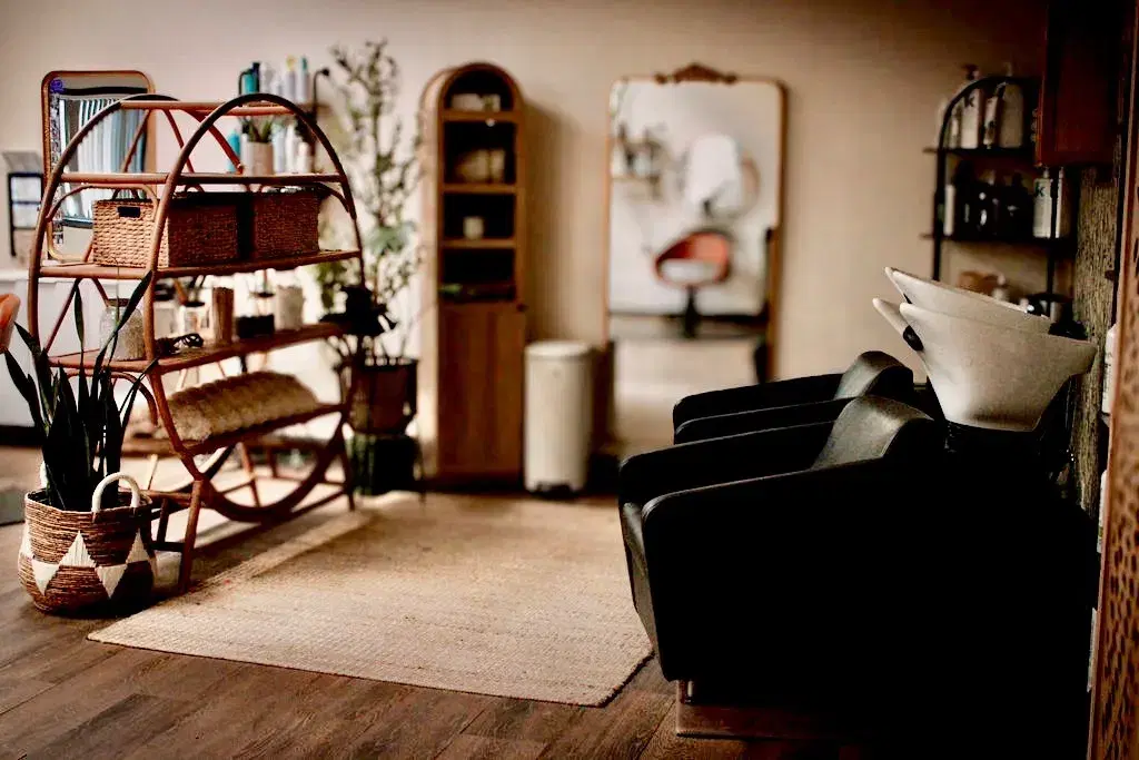 Shampoo bowls and rattan shelves in the Always Chic wash room